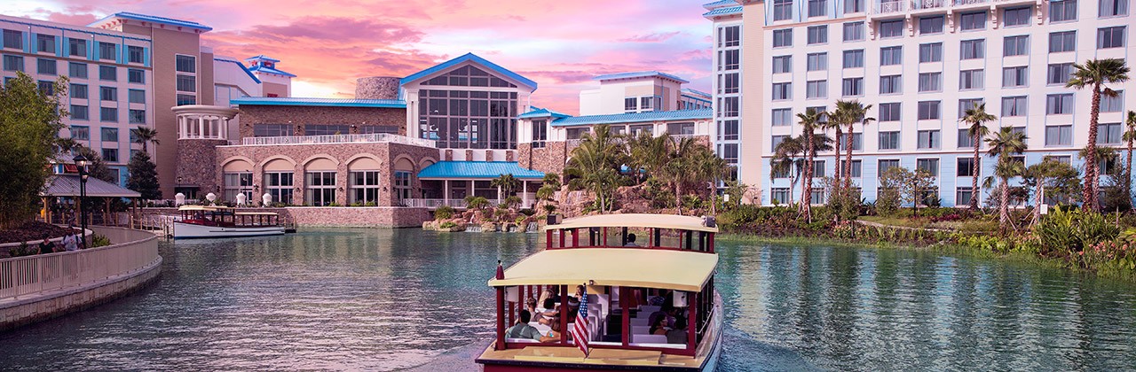 A water taxi approaches Loews Sapphire Falls Resort at Universal Orlando Resort