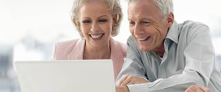 Retired couple looking at laptop