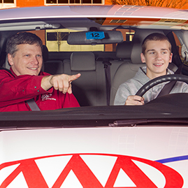 AAA driving school instructor with teen student in a car