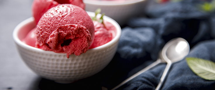 Ice cream Raspberry in white bowl on the black background.Dessert.Sorbet in the form of a ball.selective focus.