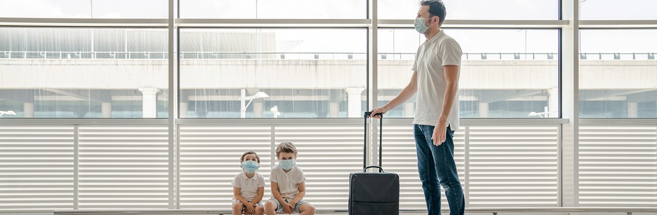 family with masks at an airport