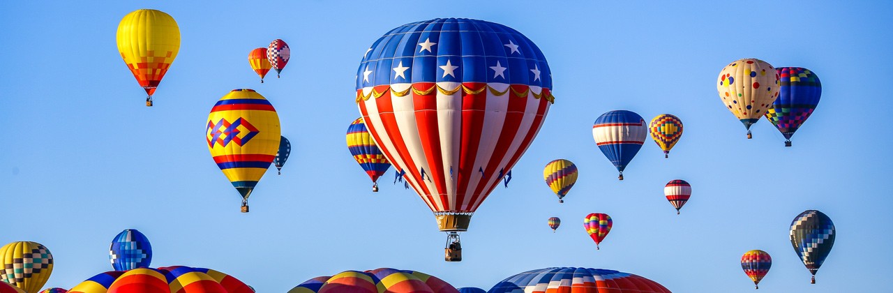 Dozens of airborne balloons at the Albuquerque International Balloon Fiesta