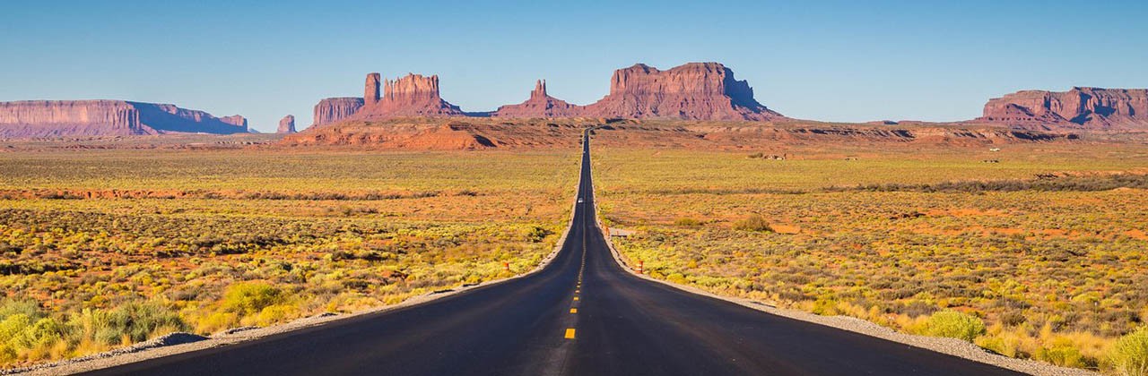 Panoramic view of U.S. Route 163 running through famous Monument Valley in Utah.