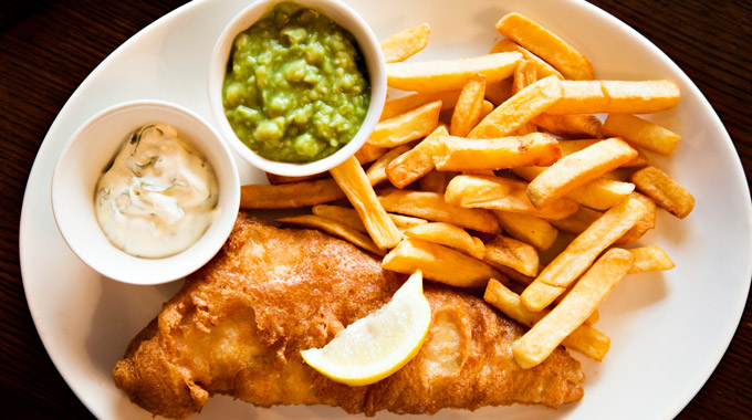 British-style fish and chips with a side of mashed peas