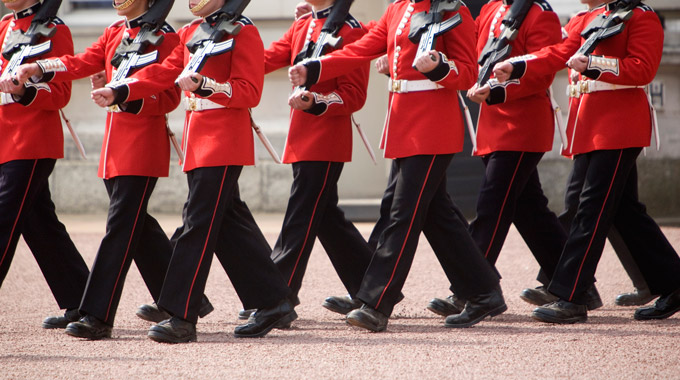 Red-coated guards marching at Buckingham Palace