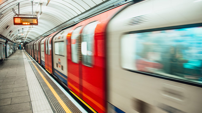 A subway train moving through a London Underground station