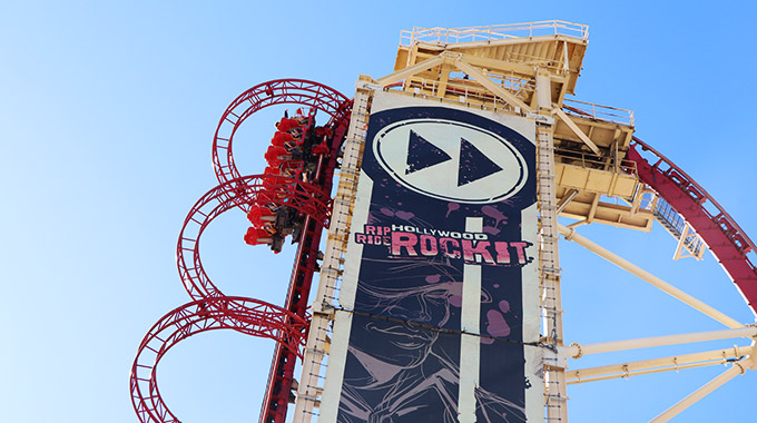 A Hollywood Rip Ride Rockit roller coaster climbs the lift tower at Universal Orlando Resort