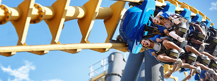 Friends riding amusement park ride