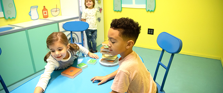 Kids playing at table at Peppa Pig's World of Play. Kids playing at table at Peppa Pig's World of Play.