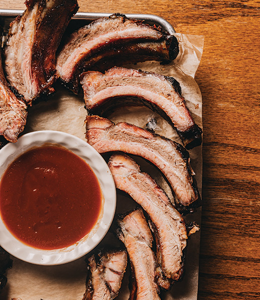 Sliced meat with a side of sauce at Golden Rule Bar-B-Q and Grill.
