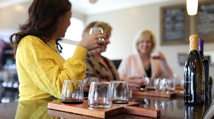 Women enjoying tasting flights inside the Noboleis Winery tasting room.