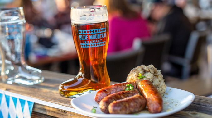 German sausage served beside a boot-shaped stein of beer