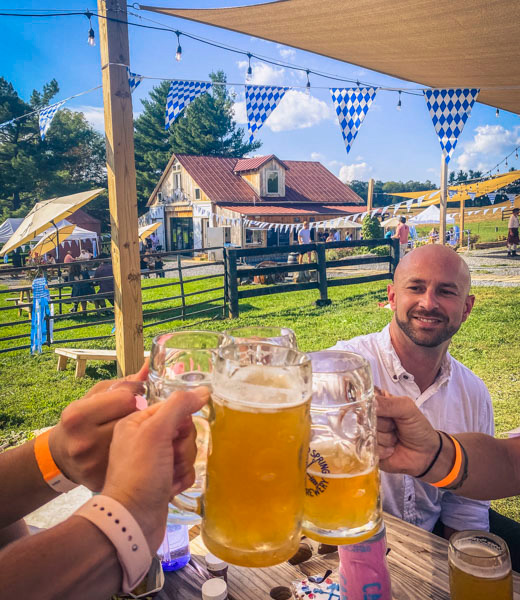 Festivalgoers toast together steins of Ursprung Festbier