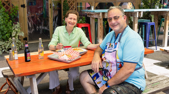 Elizabeth Johnson and Steven Pizzini seated at an outdoor dining table.