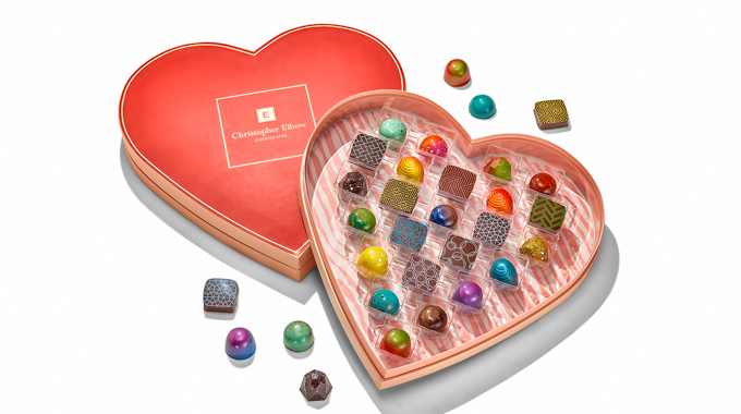 Christopher Elbow Chocolates heart-shaped box filled with bonbons in colorful designs.