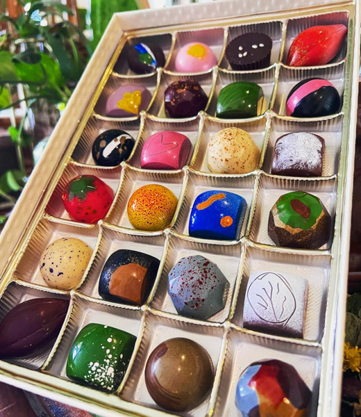 Box of bonbons with colorful designs.