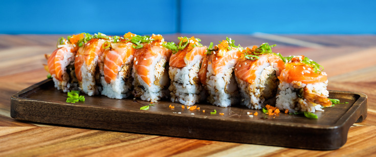 Sushi roll topped with salmon. Sushi roll topped with salmon.