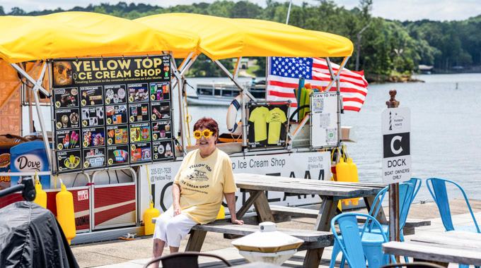 Julie Owens sitting at a picnic table near the Yellow Top Ice Cream Shop
