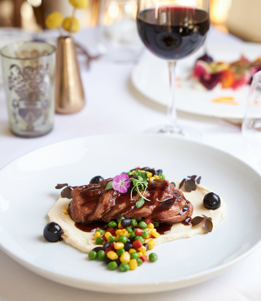 Duck breast over a bed of celery root puree and succotash.