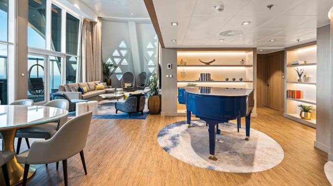 Dining area with a grand piano in the Royal Loft Suite on the Wonder of the Seas