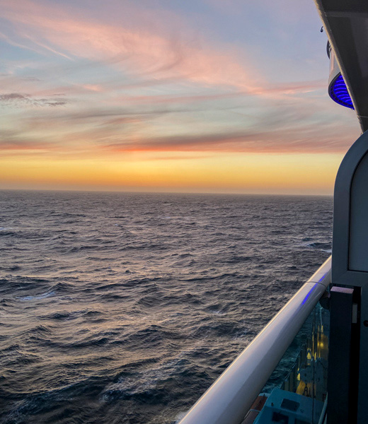Sunset view of the ocean seen from a Princess Cruises stateroom balcony.