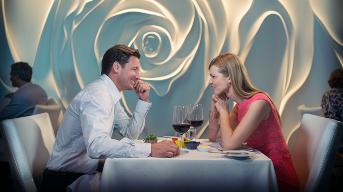 Couple enjoying red wine with their dinner