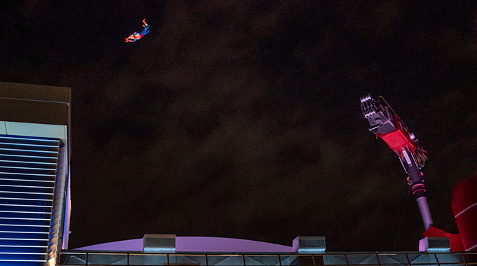 Spider-Man flips 60 to 65 feet in the air above the rooftop of the Avengers Headquarters.