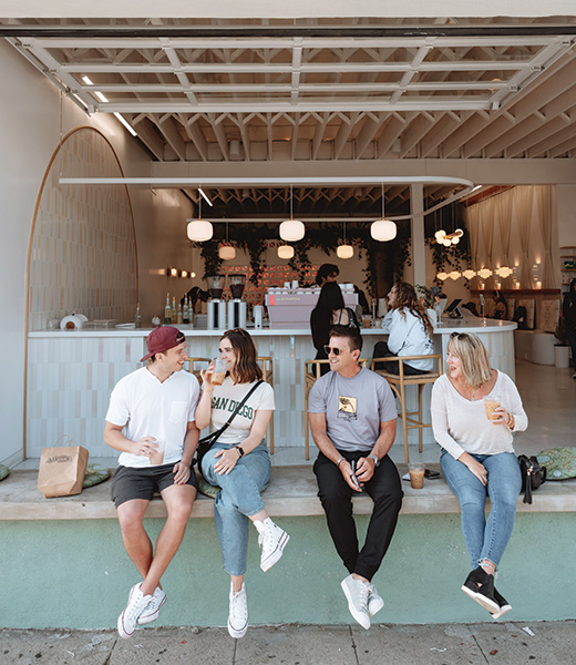 Patrons sipping their drinks in front of Lovesong Coffee.