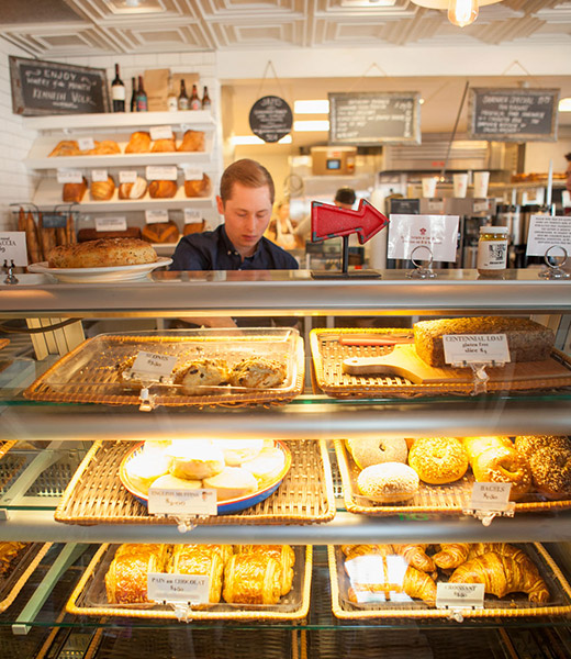 An employee behind the counter at Bob’s Well Bread bakery