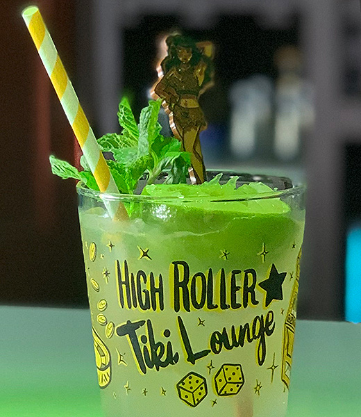 High Roller Tiki Lounge’s fanciful yellow mai tai garnished with mint and a lime