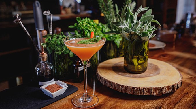 Sear Steakhouse’s Surfing Cow cocktail includes gin, Aperol, and basil