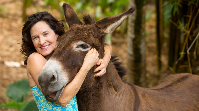 Laurelee Blanchard hugging a donkey.