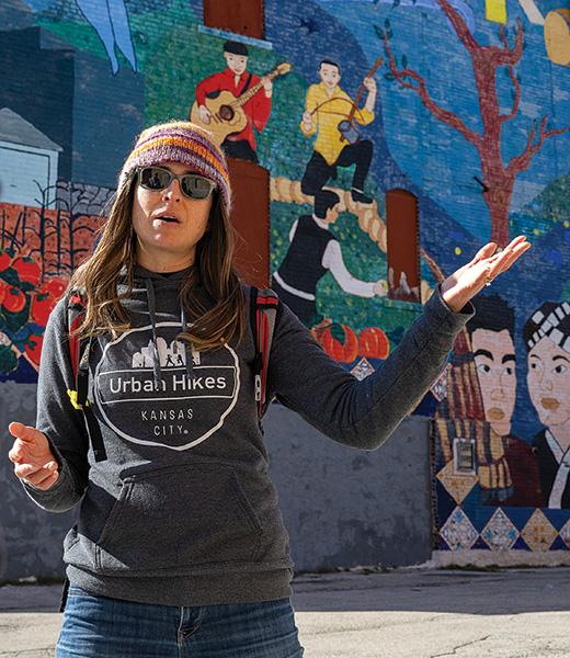 Lisa Peña in front of a mural.