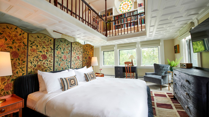 The Norumbega bi-level Library Suite, with filled bookshelves overlooking the sleeping area.