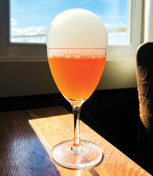 Apothecary Lounge's Aeronaut cocktail, served in a glass and topped with a citrus smoke bubble
