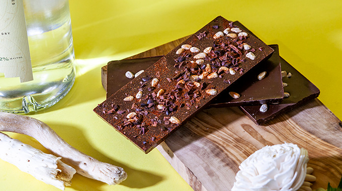 A stack of chocolate bars studded with piñon nuts