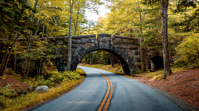 Park Loop Road curves under a picturesque bridge in Acadia National Park. | Photo by Nick Vendetta/stock.adobe.com