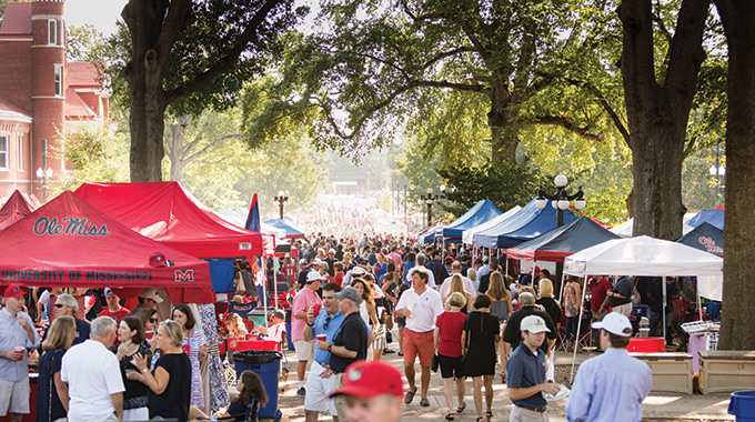 Crowds of University of Mississippi fans pack walkways at The Grove. 