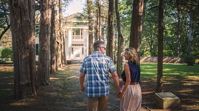 Couple walking the grounds of Rowan Oak.