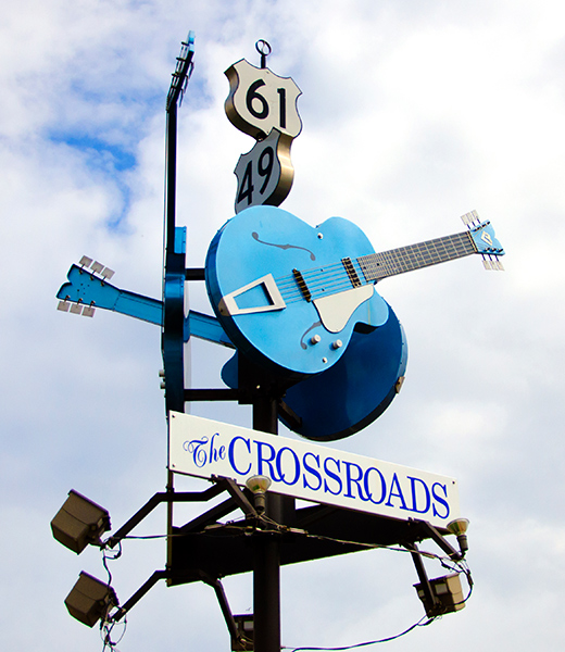 Robert Johnson Monument bearing a sign for "The Crossroads."