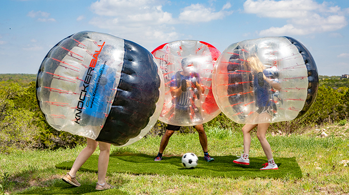 Getting a workout by kicking around a soccer ball while encased in a giant bubble is a surefire way to get a good workout. | Photo by Kenny Braun