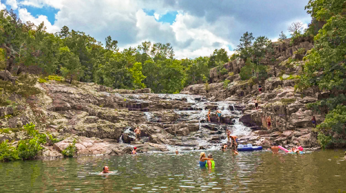 Swimmers in the pool at the base of Rocky Falls.