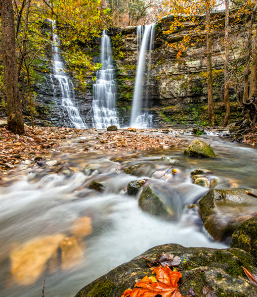 Triple Falls surrounded by fall foliage.
