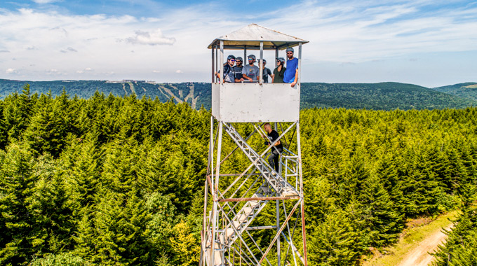 Climbers taking in the view from Snowshoe Mountain Resort fire tower.