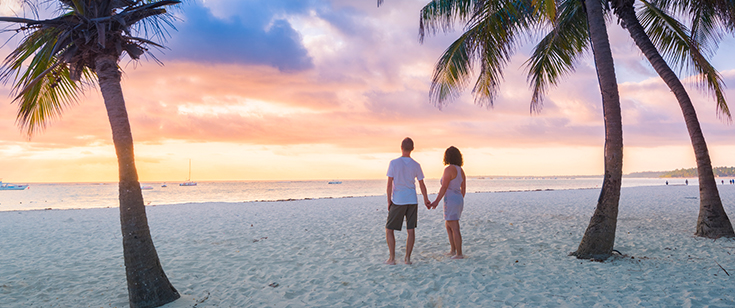 Couple on beach at sunrise Couple on beach at sunrise